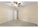 Bedroom with ceiling fan, neutral carpet, and white trim, creating a cozy atmosphere at 5761 E Emerald Oaks Ln, Acworth, GA 30102