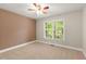 Cozy bedroom with plush carpet and a bright window, offering natural light and comfort at 5761 E Emerald Oaks Ln, Acworth, GA 30102
