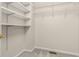Empty walk-in closet with white wire shelving and neutral carpet at 5761 E Emerald Oaks Ln, Acworth, GA 30102