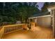 Exterior rear view of a home with an expansive deck, lush backyard, and a shed at 5761 E Emerald Oaks Ln, Acworth, GA 30102