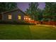 Exterior rear view of a home with beautiful backyard, mature trees, and nice deck at 5761 E Emerald Oaks Ln, Acworth, GA 30102