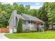 A charming gray home with an attached garage and a welcoming front porch at 5761 E Emerald Oaks Ln, Acworth, GA 30102