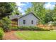 Rear view of house featuring a green lawn, side wooden fence and a deck at 5761 E Emerald Oaks Ln, Acworth, GA 30102