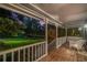 Inviting front porch with white railing and comfortable seating overlooking the lush front yard at 5761 E Emerald Oaks Ln, Acworth, GA 30102