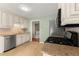 Efficient kitchen showcasing granite counters, stainless appliances, ample cabinetry, and tile flooring at 5761 E Emerald Oaks Ln, Acworth, GA 30102