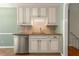 Kitchenette area featuring granite counters, stainless dishwasher, tile backsplash and ample cabinet space at 5761 E Emerald Oaks Ln, Acworth, GA 30102