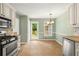 Bright kitchen with a breakfast nook offering stainless steel appliances, tile flooring, and outdoor views at 5761 E Emerald Oaks Ln, Acworth, GA 30102