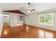 Bright living room featuring hardwood floors, natural light from large windows, and modern ceiling fan at 5761 E Emerald Oaks Ln, Acworth, GA 30102