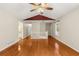 Spacious living room boasts gleaming hardwood floors, neutral paint, and a vaulted ceiling with a ceiling fan at 5761 E Emerald Oaks Ln, Acworth, GA 30102