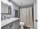 Bathroom featuring a white marble vanity, and a shower with a white shower curtain at 7307 Cardigan Cir, Sandy Springs, GA 30328