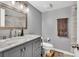 Bathroom with gray vanity, marble countertop, and updated lighting at 7307 Cardigan Cir, Sandy Springs, GA 30328