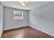 Bedroom with wood flooring and a window showing the outside greenery at 7307 Cardigan Cir, Sandy Springs, GA 30328