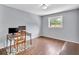 Bedroom with wood flooring, computer, and a window showing the outside greenery at 7307 Cardigan Cir, Sandy Springs, GA 30328
