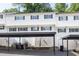 Exterior view of condo/townhouse featuring reserved parking and white siding at 7307 Cardigan Cir, Sandy Springs, GA 30328