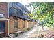 Brick townhome showcasing a second-story balcony, complemented by lush greenery and manicured landscaping at 7307 Cardigan Cir, Sandy Springs, GA 30328
