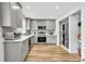 Well-lit kitchen featuring stainless steel appliances, gray cabinetry, and modern countertops at 7307 Cardigan Cir, Sandy Springs, GA 30328