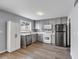 Modern kitchen features gray cabinets, stainless steel appliances, and a built-in pantry at 7307 Cardigan Cir, Sandy Springs, GA 30328