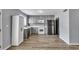 Well-lit kitchen featuring stainless steel appliances, gray cabinets, and modern hardwood flooring at 7307 Cardigan Cir, Sandy Springs, GA 30328