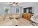 Bright living room featuring a large sectional sofa, mounted TV, and stylish furnishings at 7307 Cardigan Cir, Sandy Springs, GA 30328
