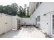 Outdoor patio with white fencing and light gray tile flooring, features an outdoor dining set at 7307 Cardigan Cir, Sandy Springs, GA 30328