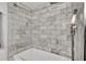 Bathroom shower stall with white and gray tiling, and handheld shower head at 7307 Cardigan Cir, Sandy Springs, GA 30328