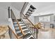 Staircase with wooden railings and black steps leading up to the second floor at 7307 Cardigan Cir, Sandy Springs, GA 30328