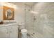 Bright bathroom featuring a marble shower, tiled walls, and a wooden-framed mirror at 80 Vinson Se Dr, Atlanta, GA 30317