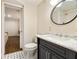 Bathroom featuring black vanity with marble countertop and a view to bedroom at 80 Vinson Se Dr, Atlanta, GA 30317