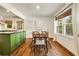 Comfortable dining area featuring hardwood floors, natural light, and stylish furnishings adjacent to kitchen at 80 Vinson Se Dr, Atlanta, GA 30317