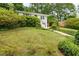 Alluring residence exhibits a lush front yard with mature trees, verdant lawn, and attached garage at 80 Vinson Se Dr, Atlanta, GA 30317