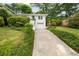 Charming white house with well-manicured lawn and garden, driveway, and a convenient one-car garage at 80 Vinson Se Dr, Atlanta, GA 30317
