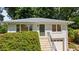 Beautiful home with a striking front door, lush green foliage, and a convenient one-car garage at 80 Vinson Se Dr, Atlanta, GA 30317