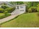 Inviting exterior view of home with a well-maintained lawn, driveway, and a staircase leading to the front door at 80 Vinson Se Dr, Atlanta, GA 30317