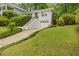 Beautiful two-story house showcasing manicured lawn, lush landscaping, and convenient attached garage at 80 Vinson Se Dr, Atlanta, GA 30317