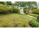 View of a lush front yard with mature trees and landscaping, complemented by a charming white house at 80 Vinson Se Dr, Atlanta, GA 30317
