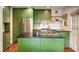 Bright kitchen featuring green cabinets, a black countertop island, and stainless steel appliances at 80 Vinson Se Dr, Atlanta, GA 30317