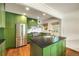 Modern kitchen with stainless steel appliances, island with sink and green cabinets at 80 Vinson Se Dr, Atlanta, GA 30317
