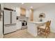 Modern kitchen with white cabinets, stainless steel appliances, and a breakfast bar with stylish seating at 80 Vinson Se Dr, Atlanta, GA 30317