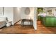 Stylish living room featuring warm hardwood floors, modern decor, and a glimpse of a stylish green kitchen at 80 Vinson Se Dr, Atlanta, GA 30317
