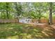 Beautiful backyard with a pristine white shed, surrounded by lush greenery and a well-maintained wooden fence at 80 Vinson Se Dr, Atlanta, GA 30317