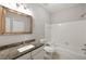 Updated bathroom features granite vanity, sleek fixtures, and a tiled shower-tub combination at 123 Mcgill Park Ave # 123, Atlanta, GA 30312