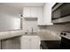 Stylish kitchen showcasing granite counters, stainless appliances, and updated fixtures at 123 Mcgill Park Ave # 123, Atlanta, GA 30312