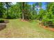 Expansive backyard with mature trees and meticulously maintained landscaping for outdoor enjoyment and privacy at 302 Chinquapin Sw Dr, Marietta, GA 30064