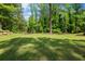 Expansive backyard with mature trees, offering ample space for outdoor activities and relaxation at 302 Chinquapin Sw Dr, Marietta, GA 30064