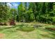 Lush backyard with a putting green and mature trees, perfect for recreation and outdoor enjoyment at 302 Chinquapin Sw Dr, Marietta, GA 30064