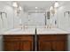 Bright bathroom featuring double sinks with marble countertops and decorative lighting at 302 Chinquapin Sw Dr, Marietta, GA 30064