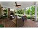 Charming covered patio with brick fireplace, ceiling fan, and comfortable seating overlooking the landscaped yard at 302 Chinquapin Sw Dr, Marietta, GA 30064