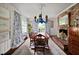 Elegant dining room with a brick fireplace, traditional furniture, and abundant natural light at 302 Chinquapin Sw Dr, Marietta, GA 30064