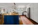 Spacious kitchen featuring a blue island, stainless steel appliances, white cabinetry, and a light-filled window at 302 Chinquapin Sw Dr, Marietta, GA 30064