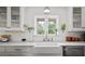 Bright and airy kitchen showcasing white cabinets, a farmhouse sink, and stylish decor accents at 302 Chinquapin Sw Dr, Marietta, GA 30064
